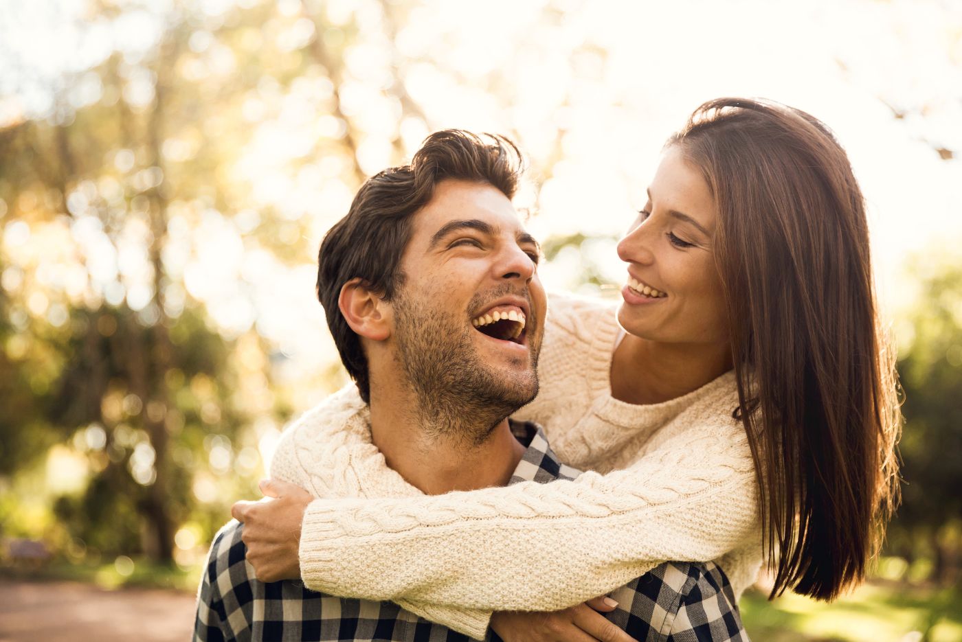Happy couple laughing outside https://www.canva.com/photos/MAD7R1hrjtg/