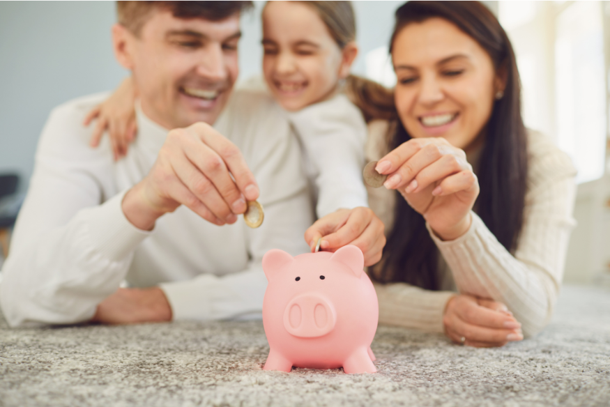 0525 Kids money apps IMAGE parents teaching kid how to use piggy bank