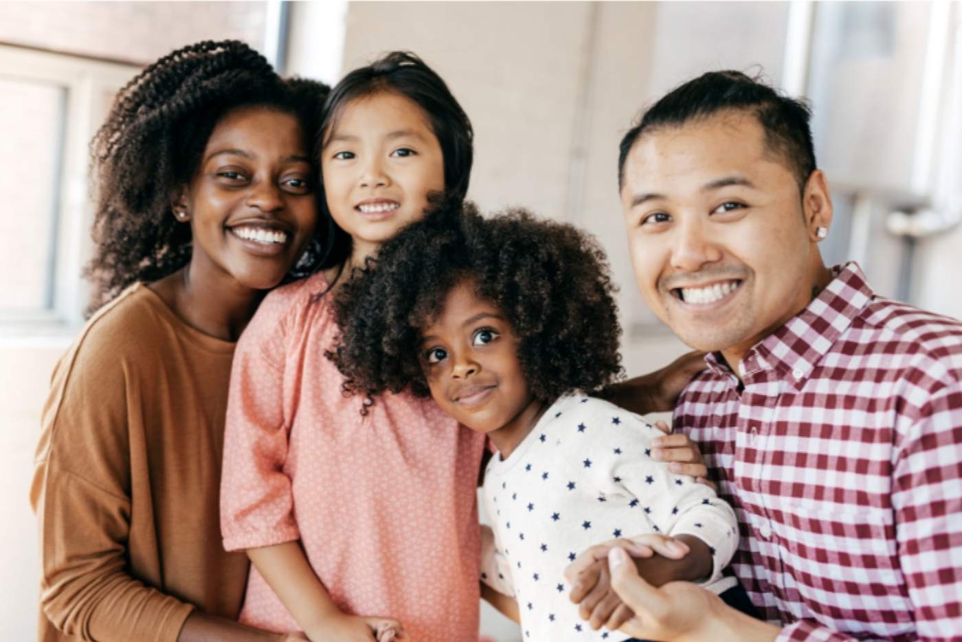 Happy blended family photo, interracial with two daughters