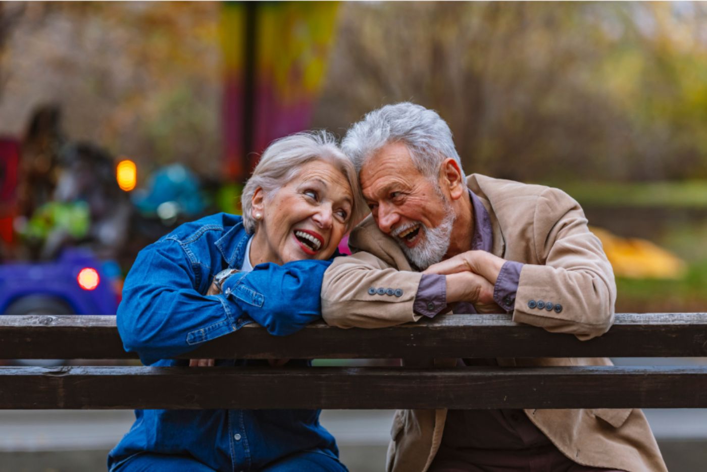 Happy older couple park bench