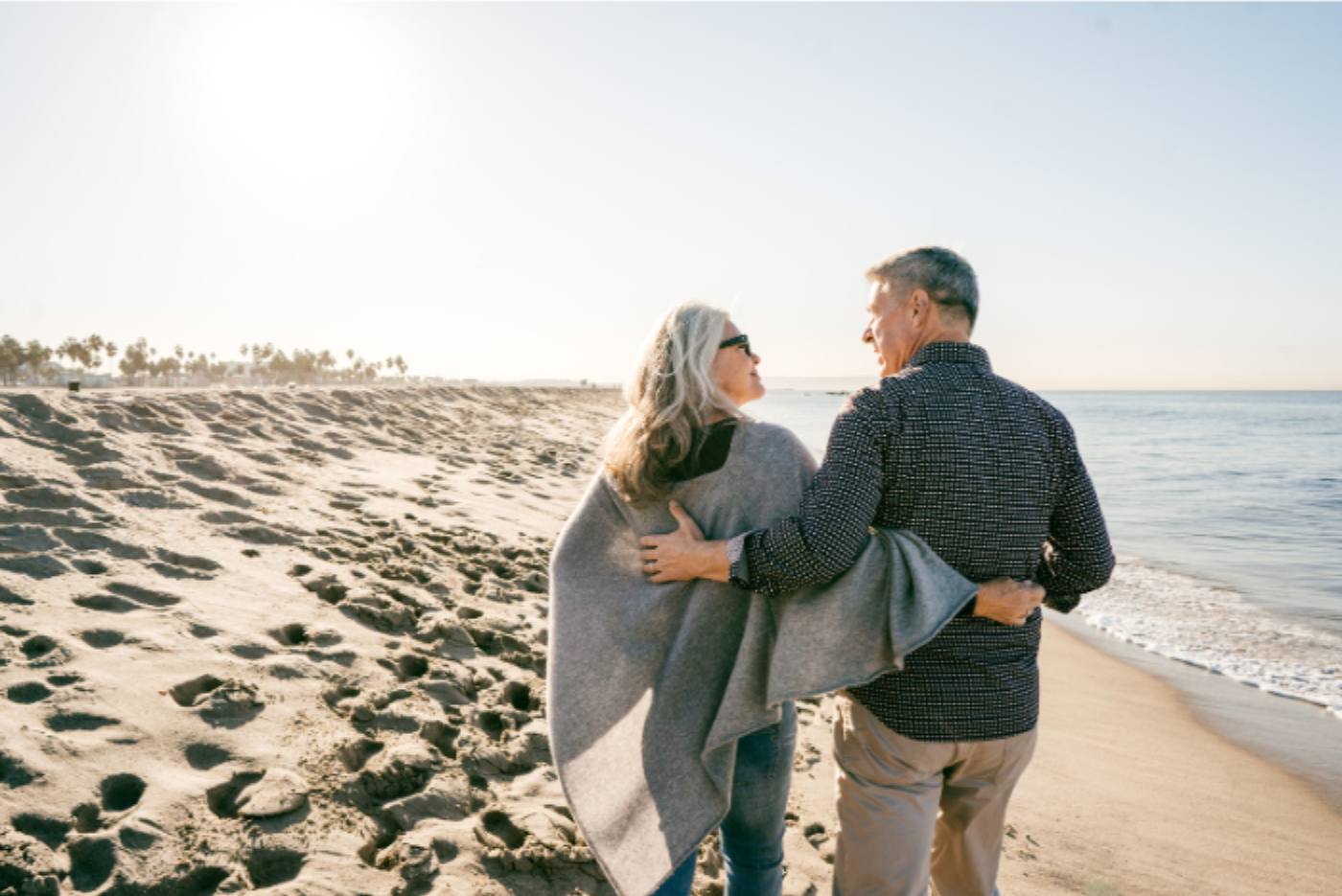 older-couple-walking-beach