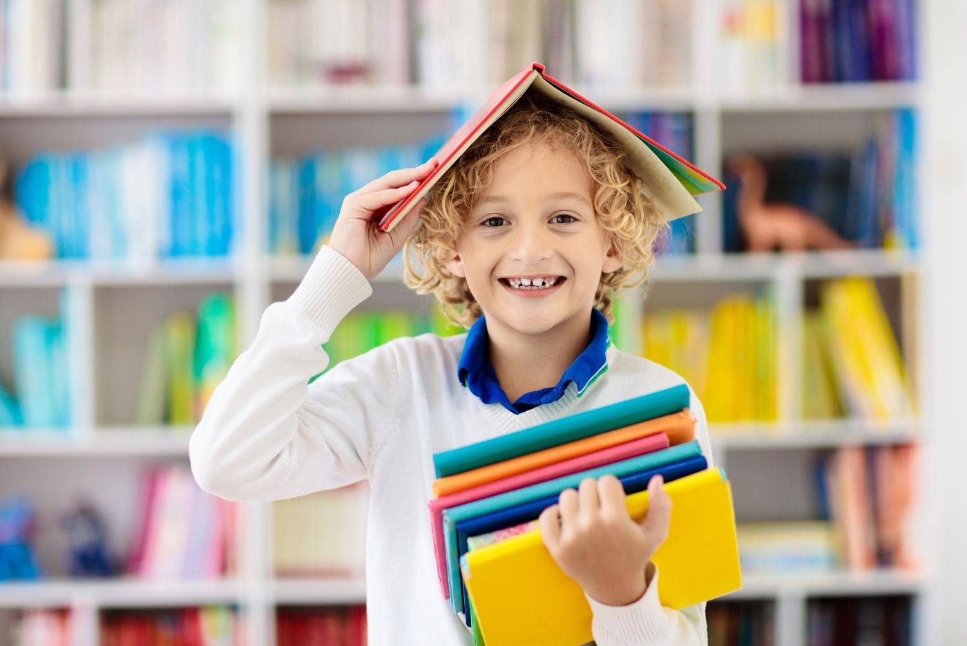 kid carrying books inside the classroom